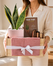 Load image into Gallery viewer, Person holding a gift box with a plant and gardening tools

